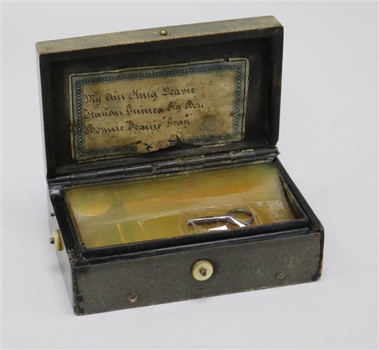 A 19th century bois durci musical snuff box